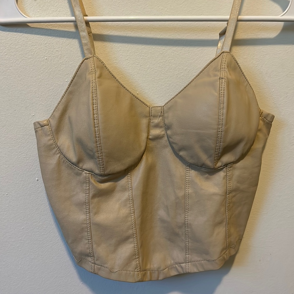 Light tan, leather material, cropped tank top.